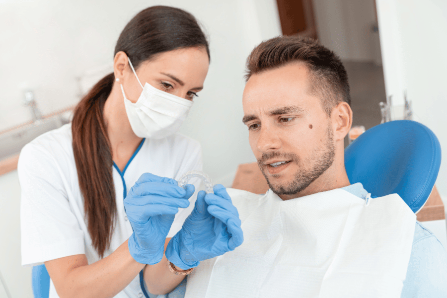 A dentist showing clear aligners