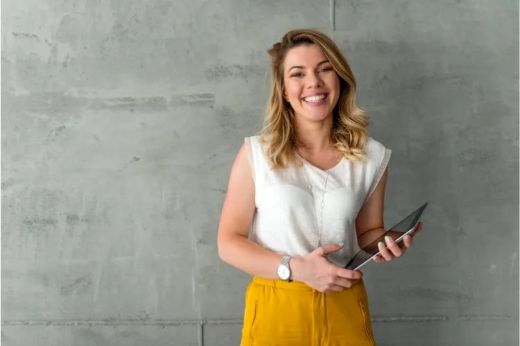 An image shows a business woman smile confidently