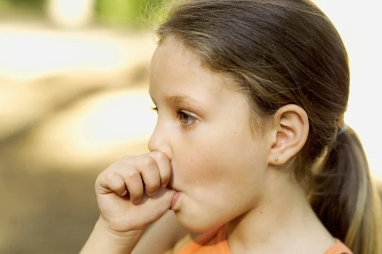 An image of a baby girl sucking her thumb