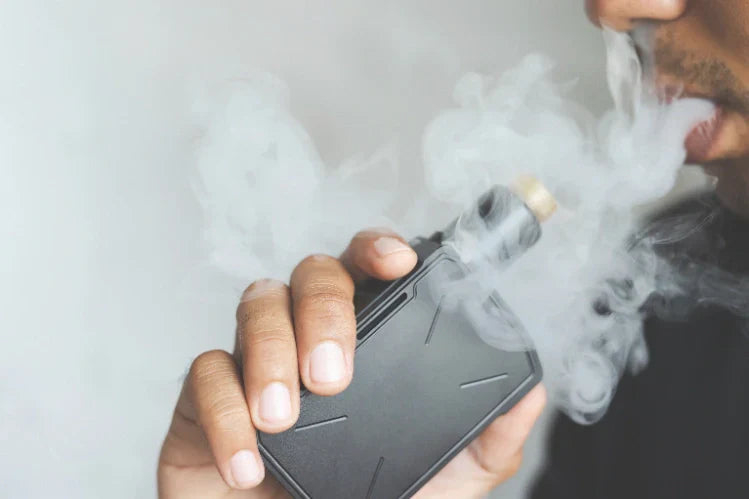 An image of a guy smoking a vape