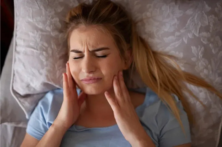 A girl feels jaw pain after waking up