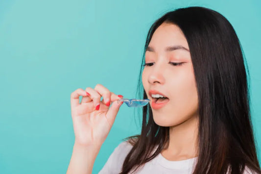 A close-up of a girl applying Hawley retainers