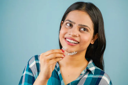 A closeup of a girl applying clear aligners. 